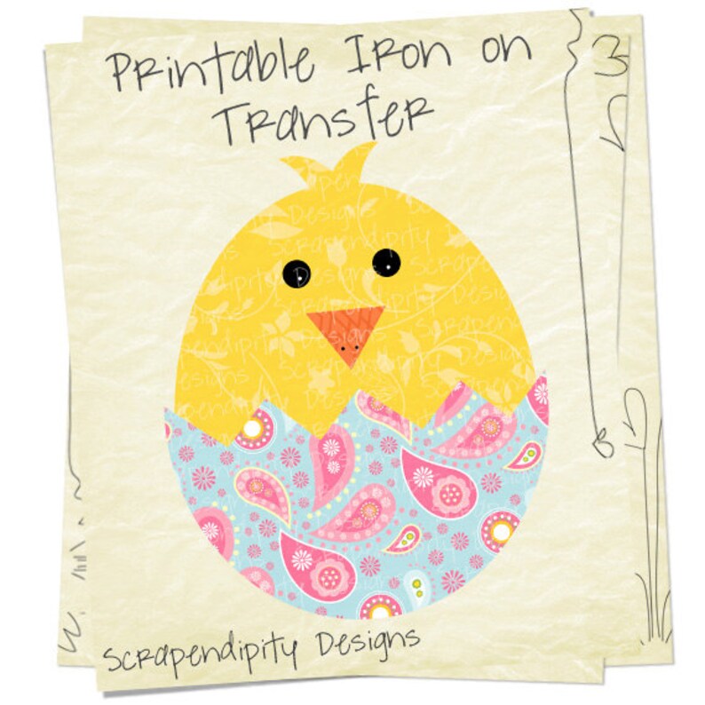 May include: Printable iron-on transfer design featuring a yellow chick peeking out of a blue and pink paisley patterned eggshell. The design says "Printable Iron on Transfer" and "Scrapendipity Designs".