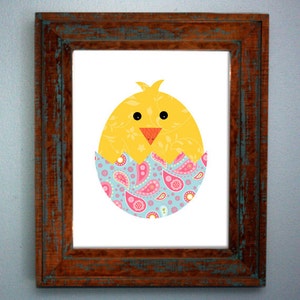 May include: A yellow chick with black eyes and a red beak peeks out of a blue and pink paisley patterned eggshell.