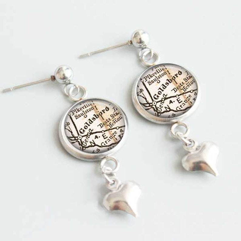 May include: Silver earrings with a heart charm and a round charm featuring a vintage map of Goldsboro, North Carolina.