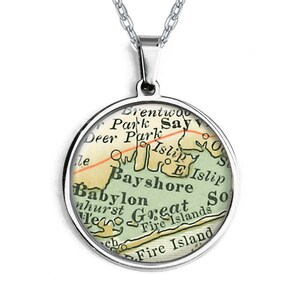May include: A silver necklace with a round pendant featuring a vintage map of Long Island, New York. The map highlights the towns of Bay Shore, Babylon, Islip, and Great South Bay.