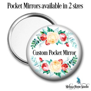 Puede incluir: Un espejo de bolsillo blanco con un diseño floral y el texto "Custom Pocket Mirror". El diseño floral presenta flores de acuarela rojas, amarillas y verdes.