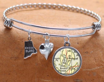 May include: A silver charm bracelet with three charms: a heart, a state outline of Rhode Island, and a vintage map of Bristol, Rhode Island.