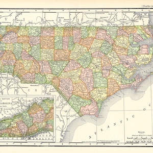 May include: A vintage map of North Carolina, showing the state's counties and major cities. The map is printed in a variety of colours, including green, yellow, orange, and pink. The map also includes a smaller inset map of the western portion of the state.