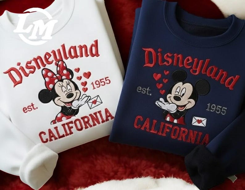 two Disney-themed sweatshirts, one white and one blue, with the text "Disneyland" and "California" printed on them.