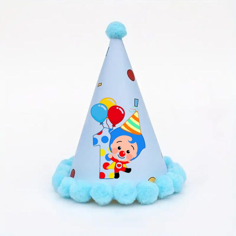 May include: A light blue party hat featuring a cartoon clown, the number 1, and balloons. The hat has a light blue pom-pom trim and a matching pom-pom on top. A festive birthday accessory.