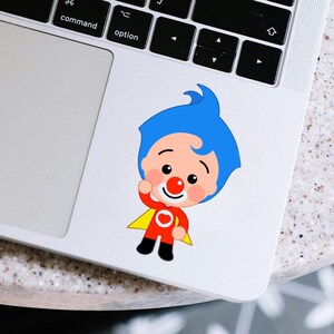 May include: A cartoon sticker of a character with blue hair, a red nose, and a red and yellow outfit. The sticker is on a laptop, with the command and option keys visible.