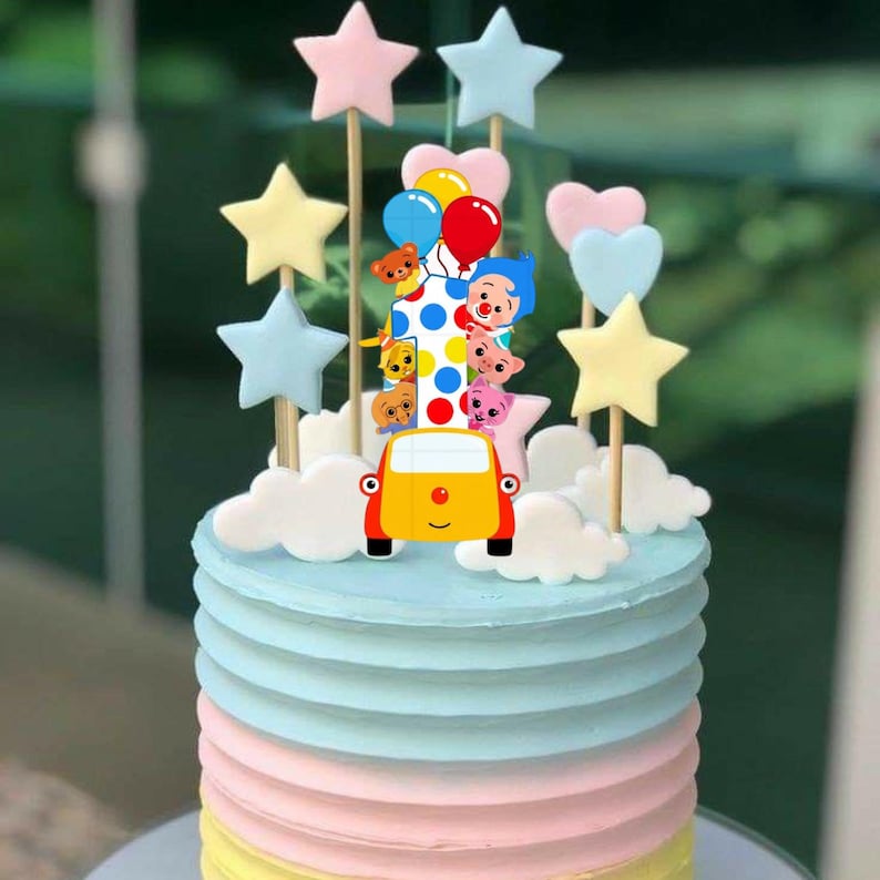 May include: A birthday cake with a yellow car and star decorations. The cake has pastel-coloured frosting and is topped with cartoon characters, balloons, and heart shapes. The cake is designed for a celebration.