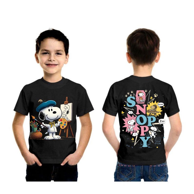 May include: Black t-shirt featuring Snoopy as an artist on the front, with a blue beret and paint palette. The back of the shirt has the word "Snoopy" in colorful letters with Snoopy illustrations.