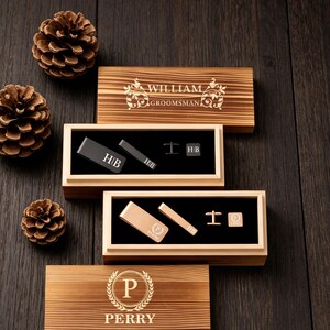 May include: Wooden gift boxes with engraved text and accessories. The boxes contain tie clips, cufflinks, and money clips. The text on the boxes reads "WILLIAM GROOMSMAN" and "PERRY". The accessories are black and gold.