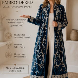 May include: A long, deep blue velvet overcoat jacket featuring intricate cream-colored Suzani embroidery. The garment includes a stand collar, long sleeves, and an open front design. Text on the image reads: SUZANI EMBROIDERED VELVET OVERCOAT JACKET.