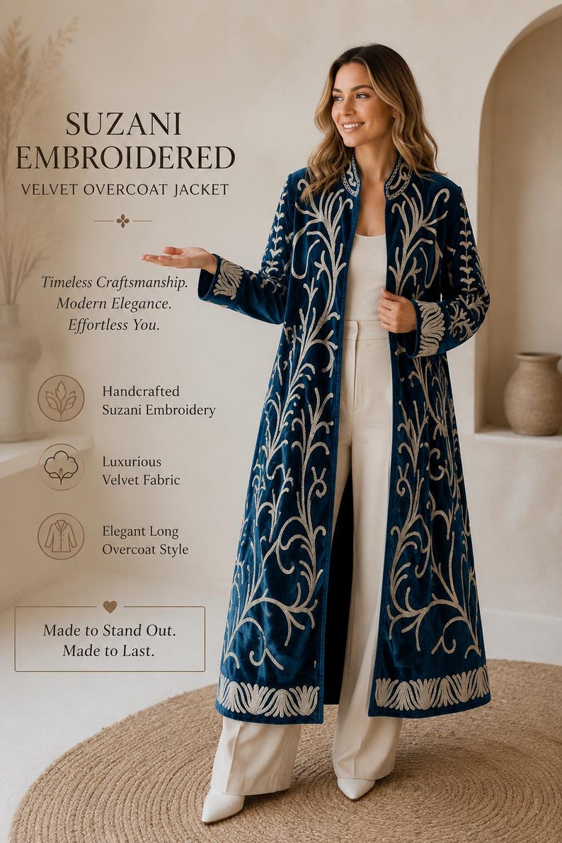 May include: A long, deep blue velvet overcoat jacket featuring intricate cream-colored Suzani embroidery. The garment includes a stand collar, long sleeves, and an open front design. Text on the image reads: SUZANI EMBROIDERED VELVET OVERCOAT JACKET.