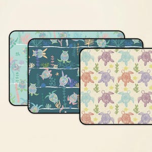 May include: Three rectangular mouse pads with rounded corners. Each pad features a different sea turtle pattern in shades of blue, green, and beige. The designs include turtles, seaweed, and starfish.