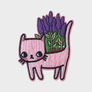 May include: A set of three ceramic mugs with a speckled, cream-colored glaze. Each mug features a different hand-painted floral design in shades of blue, green, and yellow. The mugs have a simple, rounded shape and a comfortable handle.