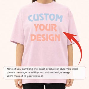 A person wearing a pink t-shirt with the text "CUSTOM YOUR DESIGN" printed on it.