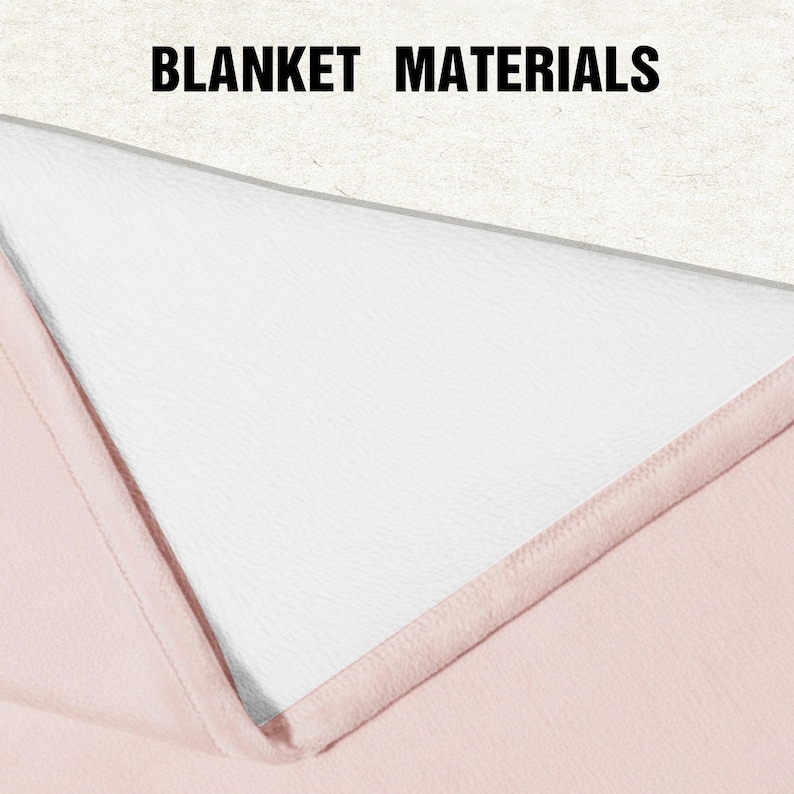 May include: A folded blanket showing two distinct layers, with the text BLANKET MATERIALS printed at the top. The top layer is a textured off-white fabric, while the bottom layer is a smooth, solid light pink fabric with stitched edges.
