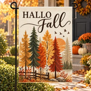 May include: A rectangular garden flag featuring the text "HALLO Fall" in black lettering above a landscape illustration of autumn trees, a wooden fence, and a setting sun. The scene includes orange, yellow, and red foliage with birds flying.