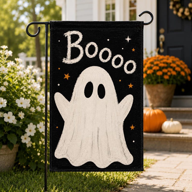 May include: A black rectangular garden flag featuring a large white ghost in the center with the text "Boooo" printed in white above it. The design includes small orange and white stars scattered across the black background.