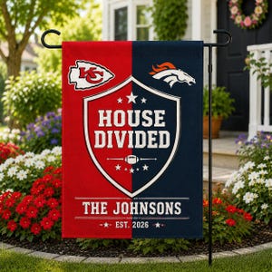 May include: A rectangular garden flag split vertically into red and navy blue sections. It features the Kansas City Chiefs and Denver Broncos logos, a central shield with the text HOUSE DIVIDED, and the custom text THE JOHNSONS EST. 2026.