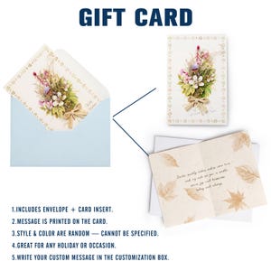 May include: A greeting card set featuring a light blue envelope and a cream-colored card with a floral bouquet illustration, a beige ribbon, and a border of small leaves. The interior displays gold-toned leaf patterns and printed cursive text.
