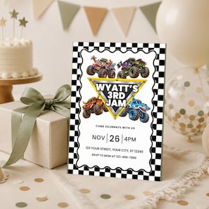 May include: A rectangular birthday invitation card with a black and white checkered border. The center features four monster trucks surrounding a yellow triangle with the text WYATT'S 3RD JAM. Below, it lists event details including date, time, and address.