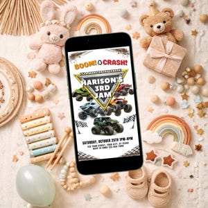 May include: A smartphone displays a birthday party invitation with monster truck graphics. The invitation reads "BOOM! & CRASH! HARISON'S 3RD JAM" with event details. The image is surrounded by toys and decorations, including a teddy bear and a rainbow.