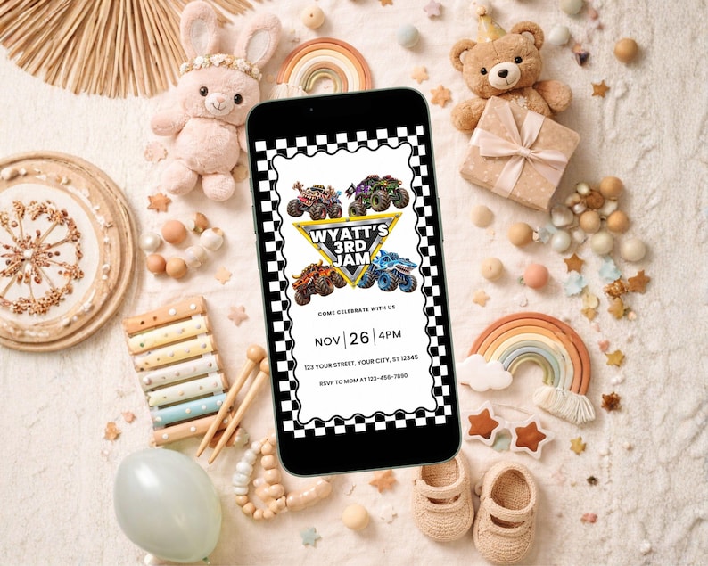 May include: A smartphone displaying a digital birthday invitation with a black and white checkered border. The graphic features four monster trucks, a yellow triangle, and the text: WYATT'S 3RD JAM, COME CELEBRATE WITH US, NOV 26 4PM.