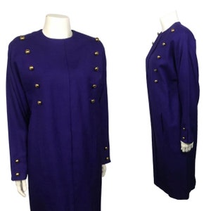 May include: A long-sleeved, purple dress with gold buttons down the front and on the sleeves.