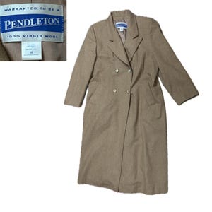 May include: A long, brown wool coat with a double-breasted closure and two front pockets. The coat has a label that reads "Pendleton 100% Virgin Wool" and "Warranted to be a Pendleton".