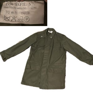 May include: Olive green military jacket with two front pockets and star insignias on the shoulders. The jacket has a button-up front and long sleeves. A tag in the upper left corner has text.