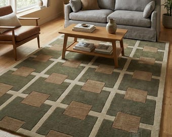 May include: A geometric patterned area rug in shades of green, tan, and brown. The rug features a repeating square design, with a light tan border. The rug is placed in a living room setting with a sofa, coffee table, and armchair.