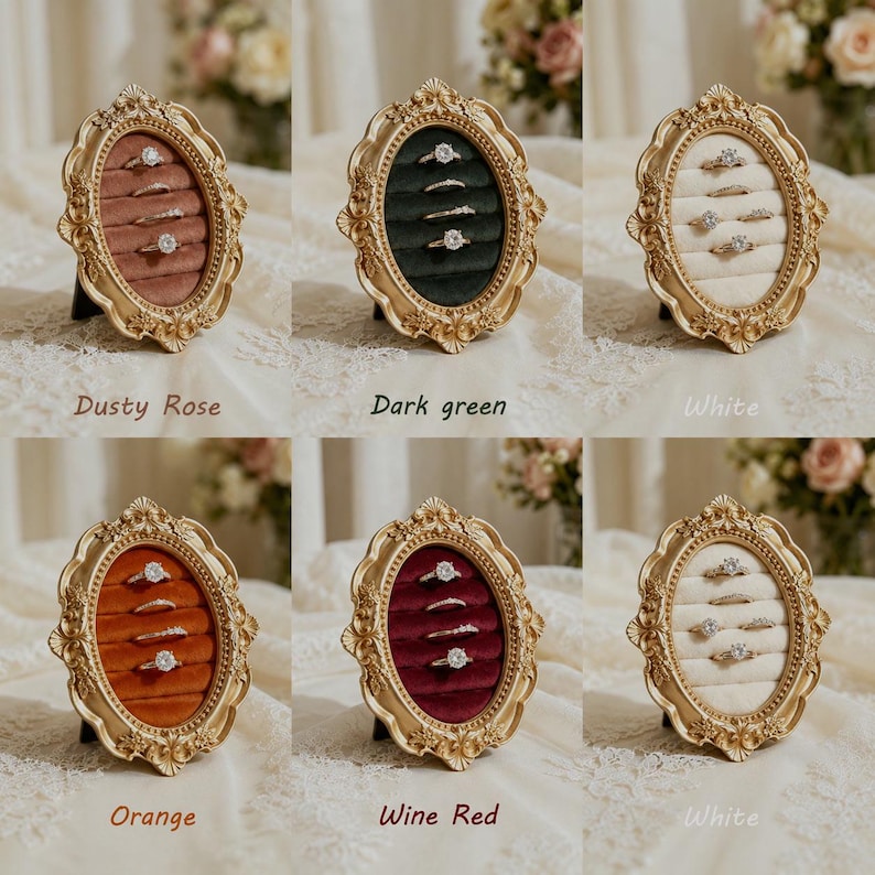 May include: Six oval ring display holders with ornate gold-toned frames and velvet-lined interiors. Each frame features horizontal slots for holding rings. The velvet colors include dusty rose, dark green, white, orange, and wine red.