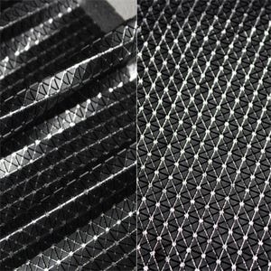 May include: A black fabric featuring a repeating geometric pattern of small, raised triangular shapes. The surface has a glossy, reflective finish that catches the light, creating a grid-like texture across the material in a structured arrangement.