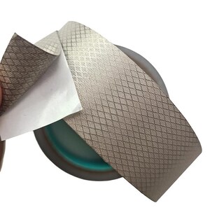 May include: A set of three ceramic mugs with a speckled, matte finish. The mugs are in shades of cream, light gray, and dark gray. Each mug has a simple, minimalist design and a rounded handle.
