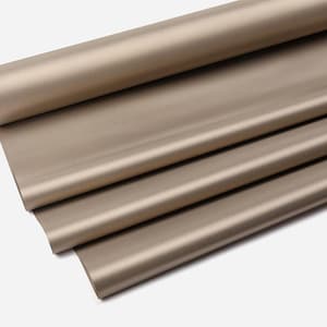 May include: A roll of tan-colored wrapping paper, partially unrolled to reveal several layers. The paper has a smooth, matte finish and appears to be made of a lightweight material. The paper is folded and rolled, creating a layered effect.
