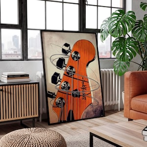 May include: A framed art print featuring a close-up of a bass guitar headstock. The headstock is orange with black tuning pegs and strings. The artwork has a vintage, distressed look with a cream-colored background and a black frame.