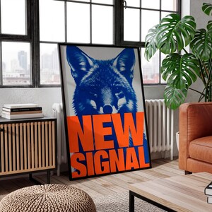 May include: A framed art print featuring a blue fox illustration with the words "NEW SIGNAL" in bold orange letters. The artwork has a modern, graphic design aesthetic, suitable for home or office decor.