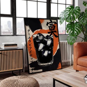 May include: A framed poster featuring a graphic illustration of a dark beverage with ice cubes in a glass. The poster has Japanese text and a background of orange and black brushstrokes. The poster is leaning against a window.