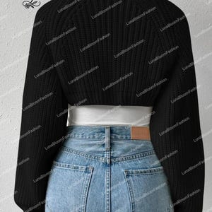 May include: A black cropped sweater with long sleeves and a round neckline. The sweater is paired with light blue denim jeans. The brand name "LunaBloomFashion" is visible in the upper left corner.