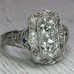 Art Deco Two Stone Diamond Engagement Ring with Ornate Filigree, Scroll Work, and Blue Sapphire Accents in White Gold or Silver