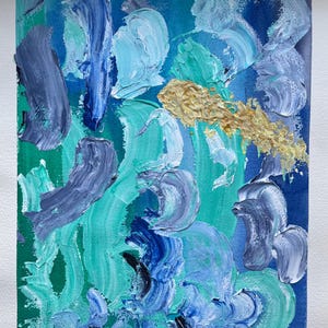 May include: Abstract painting with textured brushstrokes in shades of blue, teal, and white, with a touch of gold. The artwork features thick, layered paint, creating a dynamic and expressive composition. Signed "Miriam Elena".