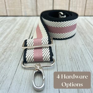 May include: A black, white, and pink striped bag strap with silver hardware. The strap is rolled up and also shown with a silver clasp and rectangular hardware. Text in the image reads "4 Hardware Options".
