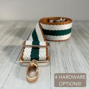 May include: A woven bag strap featuring a striped pattern of dark green and white, accented with brown edges and gold-toned metal hardware, including a lobster clasp and an adjustable slider. The text 4 HARDWARE OPTIONS! is visible.