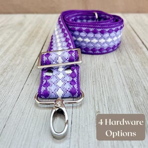 May include: A purple and white patterned strap with silver hardware, including a buckle and a swivel clasp. The strap is rolled up in the background. Text in the image reads "4 Hardware Options".