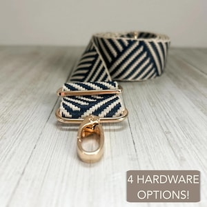 May include: A navy blue and cream woven bag strap featuring a diagonal chevron pattern. The strap includes gold-tone metal hardware with a lobster clasp and an adjustable slider. A text box in the corner reads 4 HARDWARE OPTIONS!