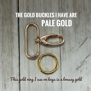 May include: A pale gold swivel lobster clasp with an oval loop and a separate brassy gold circular ring. The text in the image reads: THE GOLD BUCKLES I HAVE ARE PALE GOLD and This gold ring I use on bags is a brassy gold.