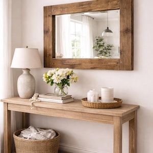 Large rustic reclaimed wood mirror styled in multiple interiors including bedroom, bathroom and living room.