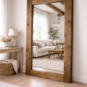 Large rustic reclaimed wood mirror styled in multiple interiors including bedroom, bathroom and living room.