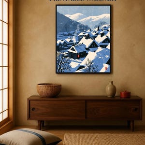 May include: A framed wall art print featuring a snowy Japanese village scene with dark wooden houses covered in thick white snow, blue mountain silhouettes in the background, and a single red lantern, with the text INSTANT DOWNLOAD PRINTABLE WALL ART.