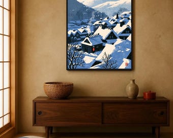 May include: A framed wall art print featuring a snowy Japanese village scene with dark wooden houses covered in thick white snow, blue mountain silhouettes in the background, and a single red lantern, with the text INSTANT DOWNLOAD PRINTABLE WALL ART.