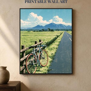 May include: A framed wall art print featuring a blue bicycle leaning against a wooden fence beside a road. The scene depicts a green field, distant mountains, and a blue sky with white clouds. Text at the top reads INSTANT DOWNLOAD PRINTABLE WALL ART.